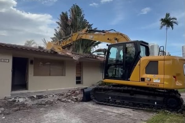 Home demolition with excavator